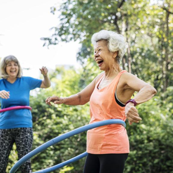 Senior woman exercising with a hula hoop